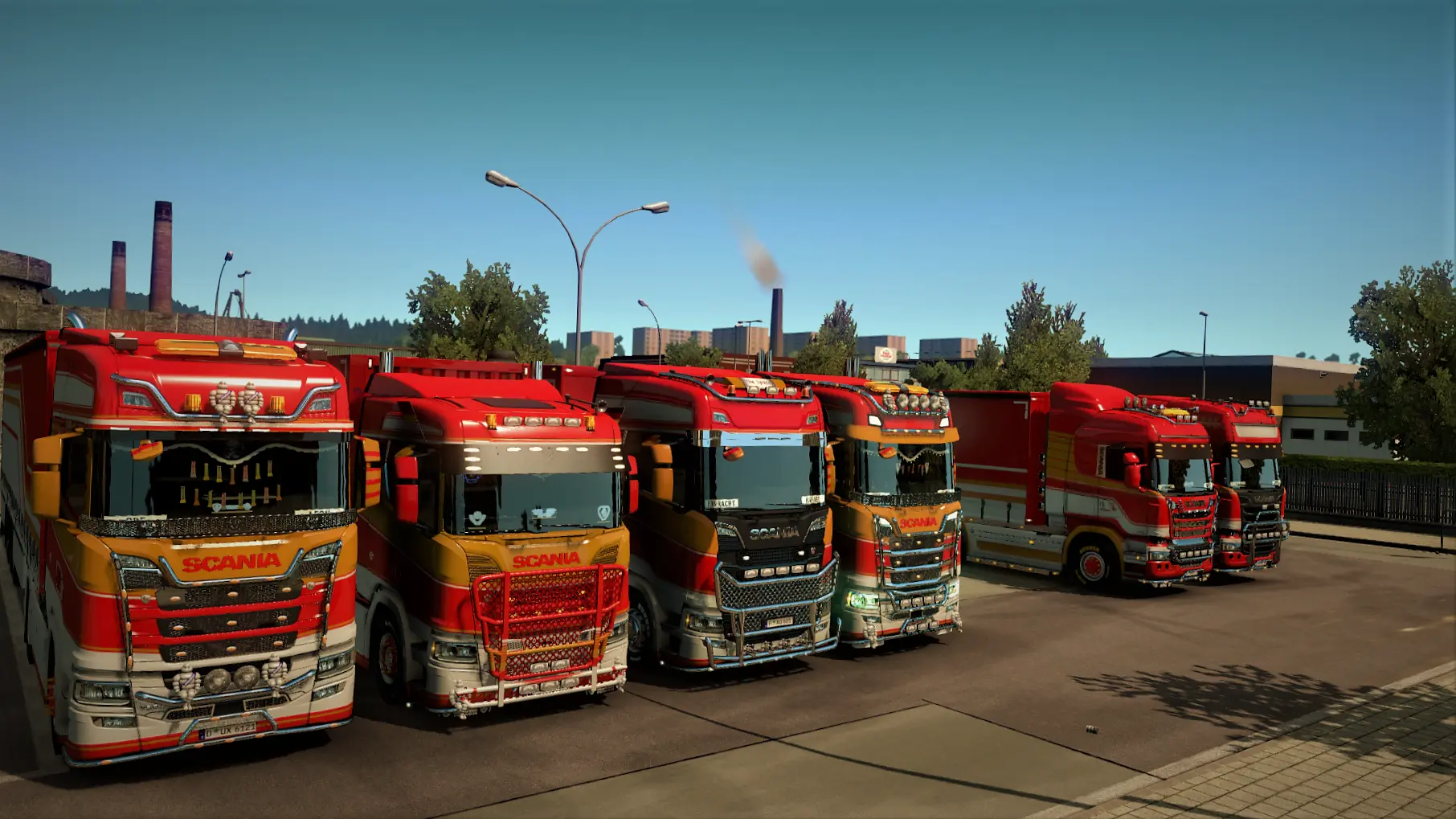 A line of parked GPE trucks all wearing the new red & gold livery