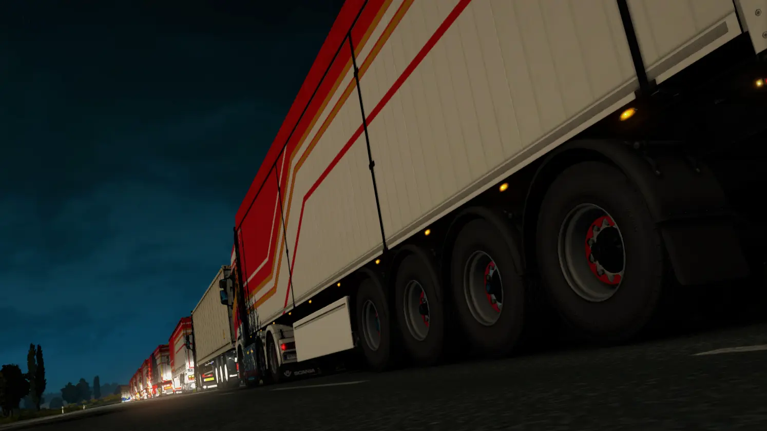 A line of GPE trucks attending a convoy, the time of day is night and its overcast