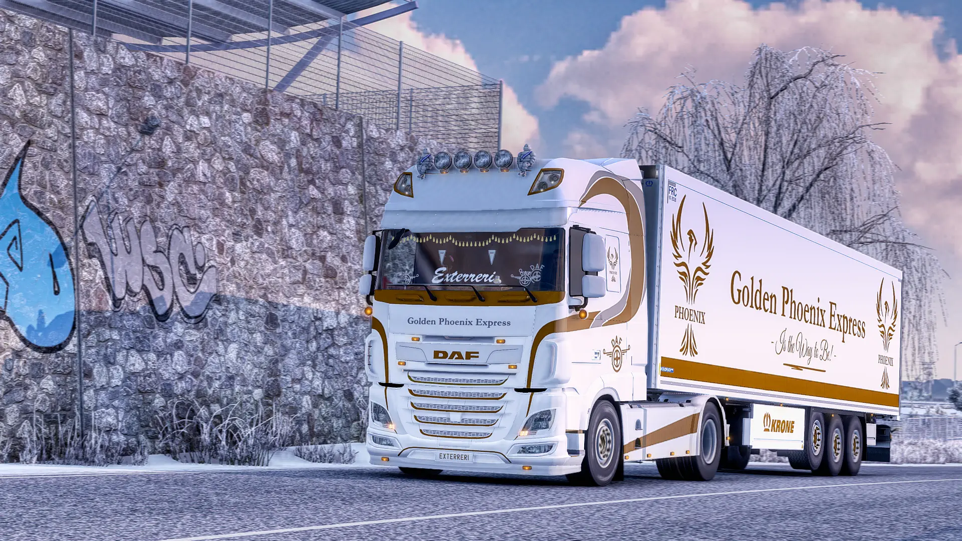A GPE truck driving along a road with a light amount of snow, the truck has as a truck and trailer that read 'Golden Phoenix Express'